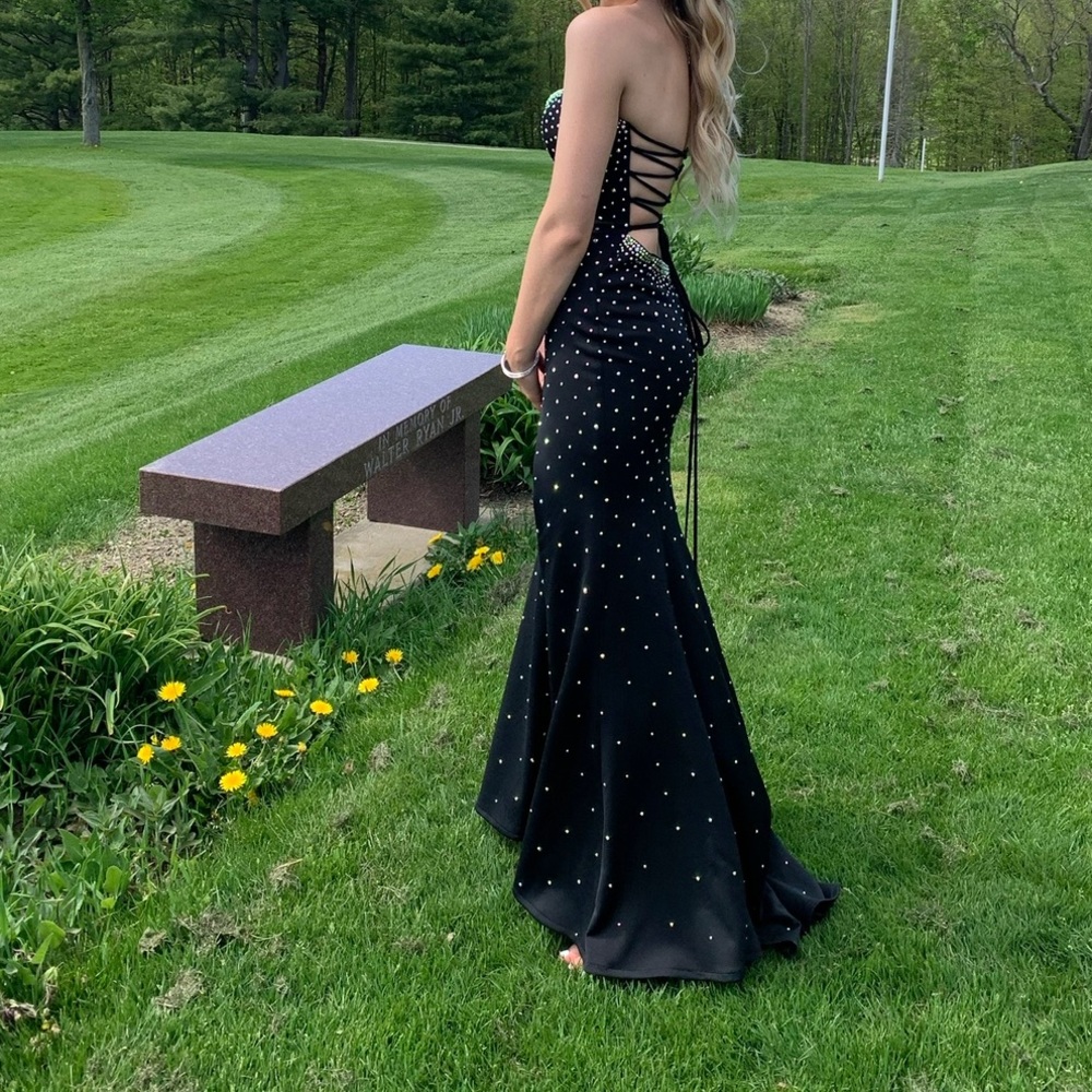 Jovani size 4 fits like a size 2. Black with rhinestones laced back